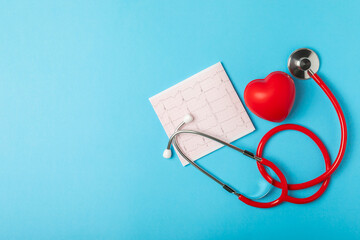 Medical stethoscope, red heart, and cardiogram on a color background. ECG, Heart wave, heart attack, cardiogram report. Cardiogram pulse trace and heart concept. Healthcare.Space for text