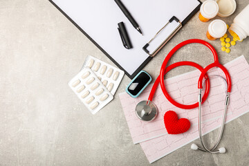 Medical stethoscope, red heart, and cardiogram on a color background. ECG, Heart wave, heart attack, cardiogram report. Cardiogram pulse trace and heart concept. Healthcare.Space for text