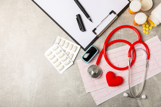 Medical stethoscope, red heart, and cardiogram on a color background. ECG, Heart wave, heart attack, cardiogram report. Cardiogram pulse trace and heart concept. Healthcare.Space for text - Powered by Adobe