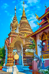 Fototapeta premium Ho Rakang belfry in front of Chedi of Wat Saen Muang Ma, Chiang Mai, Thailand