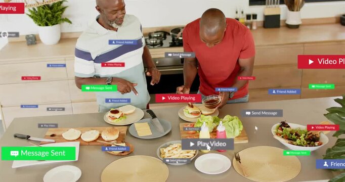 Senior man pointing, causing social UI overlays, guiding adult man spooning sauce onto burgers