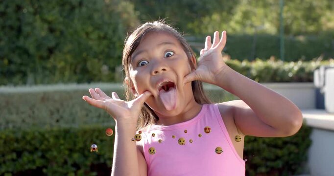 After smile, girl pulling cheeks, sticking tongue out, emojis floating around hands, social media