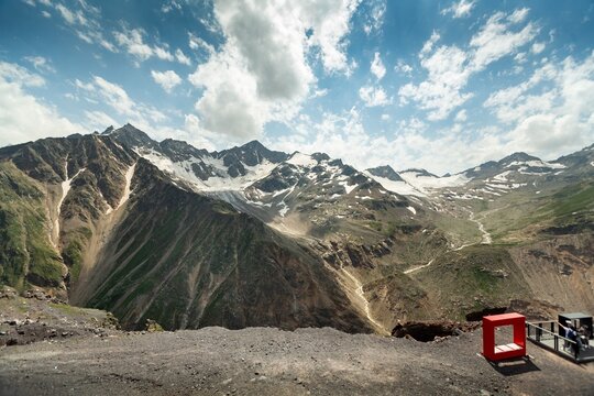 Winter landscape snow-capped mountains bathed in morning. Snow valleys below.