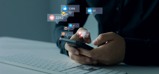 Person using smart phone with emoticon icons of Social Media.Interactive with friends on chat with emoticon feedback.Social media,marketing, like,social network,blog,live,chat reaction and livestream.