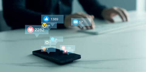 Person using smart phone with emoticon icons of Social Media.Interactive with friends on chat with emoticon feedback.Social media,marketing, like,social network,blog,live,chat reaction and livestream.
