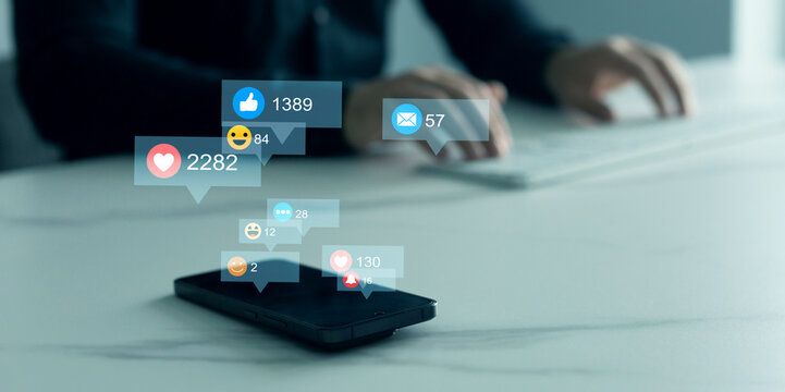 Person using smart phone with emoticon icons of Social Media.Interactive with friends on chat with emoticon feedback.Social media,marketing, like,social network,blog,live,chat reaction and livestream.