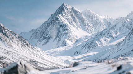 Fototapeta premium Aerial view of majestic snowy mountains showcasing rugged peaks and serene valleys, capturing the essence of untouched wilderness and natural beauty