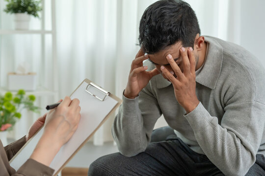 man with mental health problems is consulting. psychiatrist is recording the patient's condition for treatment. encouragement, love and family problem, bipolar , depression patient, protect suicide