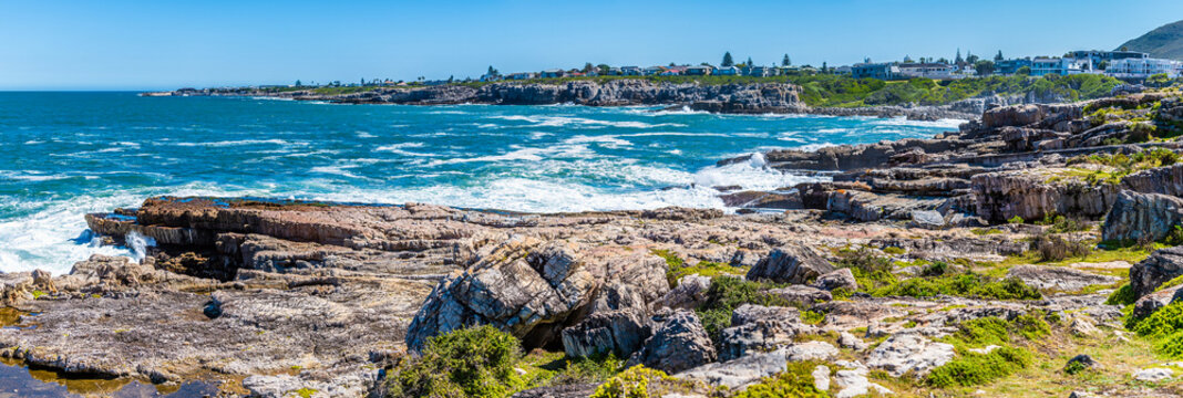 A panorama view past the rocky shoreline towards Gearings Point at Hermanus, South Africa in springtime