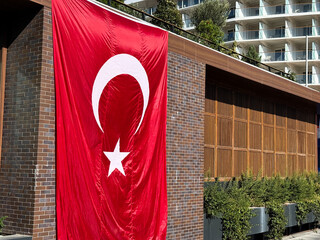 Turkish national flag hanging on building facade in luxury shopping complex