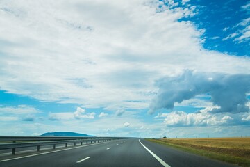 Fototapeta premium Asphalt highway road with blue sky