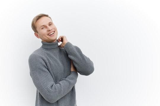 smiling young caucasian man wear gray knitted sweater casual pose look camera gesture digital detox concept isolated white background