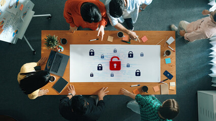 A diverse team collaborates in a modern office environment, focusing on cybersecurity solutions illustrated with lock icons symbolizing digital protection and data security strategies. Trope