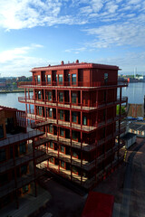 Fototapeta premium Sustainable cabins with natural materials on waterfront in Kvillepiren, Hisingen, sunny day, Gothenburg, Sweden