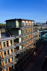 Fototapeta premium Sustainable cabins with natural materials on waterfront in Kvillepiren, Hisingen, sunny day, Gothenburg, Sweden
