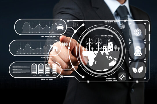 Businessman interacting with futuristic wind energy data interface showcasing analytics, graphs, and renewable energy icons in digital format