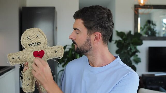 Comedic video of a man with esoteric experience holding traditional voodoo doll during Halloween 