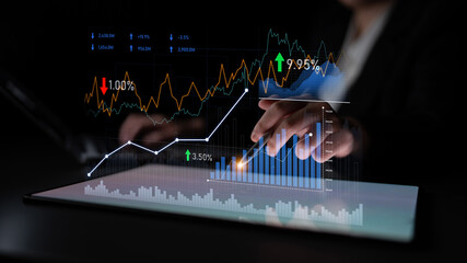 A professional business setting showing hands interacting with digital analytics and financial charts on a tablet, highlighting data trends and statistics. Scalp