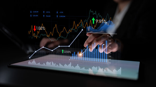 A professional business setting showing hands interacting with digital analytics and financial charts on a tablet, highlighting data trends and statistics. Scalp