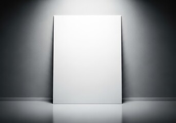 Blank white poster leaning against a textured wall in a spotlight, with a reflective floor