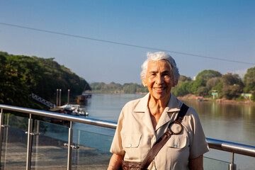 Senior woman at the Ronda del Sinu walking path along the river bank in the city of Monter&iacute;a, Colombia.
