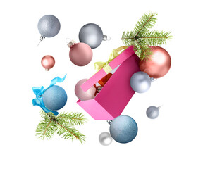 Christmas balls, gift box and fir tree branches in air on white background