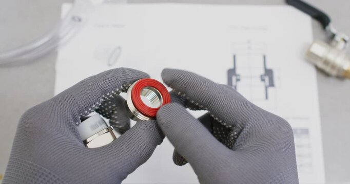 Installer aligns union fitting to valve body checking thread engagement. Plumber tightens cap nut and compresses gasket ring confirming leak free seat during assembly