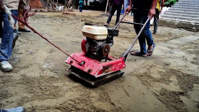 Construction Workers Leveling Ground
