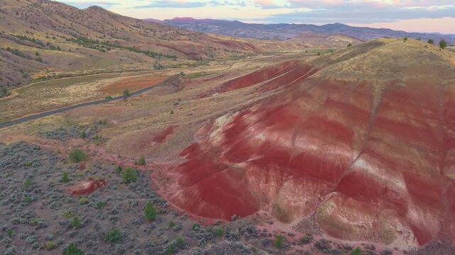A magnificent aerial panorama capturing the rolling hills and striated landscape near the Painted Hills at John Day Fossil Beds National Monument area at sunrise