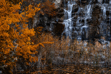 Mystic cascade of water flows gently over dark rocks