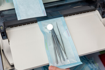 A medical professional uses a constant heat sealing machine