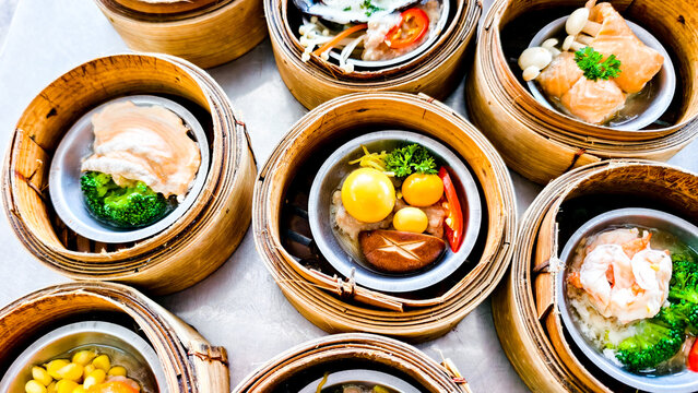 Exquisite Dim Sum Delight: A vibrant collection of delectable dim sum presented in traditional bamboo steamers, enticing viewers with their colorful ingredients and culinary artistry.