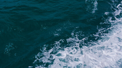 Ocean's Rhythmic Embrace: A captivating view capturing the dynamic dance of water as it swirls, crashes, and froths, embodying the raw power and beauty of the sea.