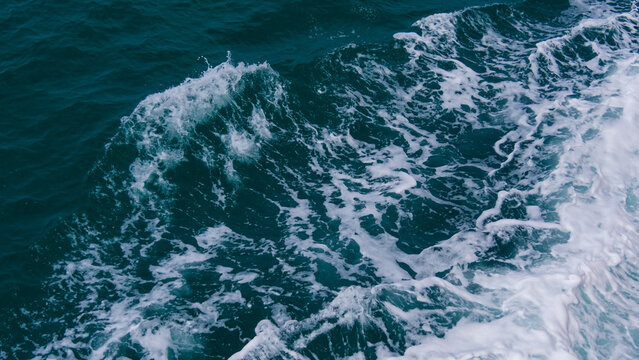 Ocean Waves in Motion: Capturing the dynamic beauty of the ocean with frothy, churning waves and the immense power of nature's forces, the image speaks to the depths of the sea.