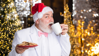 Ho Ho Ho. morning before xmas. Cooking christmas meal. Easy ideas for christmas party. Santa Claus enjoying served gingerbread cake and milk. santa grandpa drink milk and eat xmas cookies. for santa