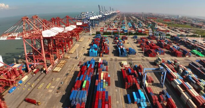 Unloading large cargo containers seaport. Loading freight sea port. Top aerial drone view. Lot big boxes rows, ship delivery ocean harbor. Industrial Shipping day. Goods export import. Marine dock.