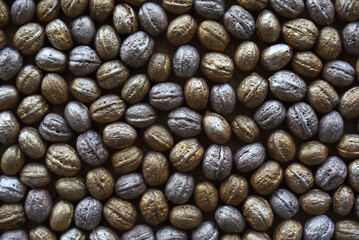 Gray-golden background of walnut shells