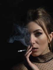 Obraz premium Girl in black with a cigarette. High quality photo