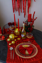 Elegant Christmas Table Setting with Red and Gold Decorations