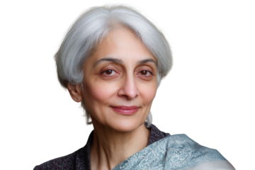 Elderly Indian woman with white hair smiling gently on neutral background.