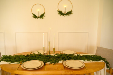 A beautifully arranged dining table features greenery and candles creating a warm atmosphere 