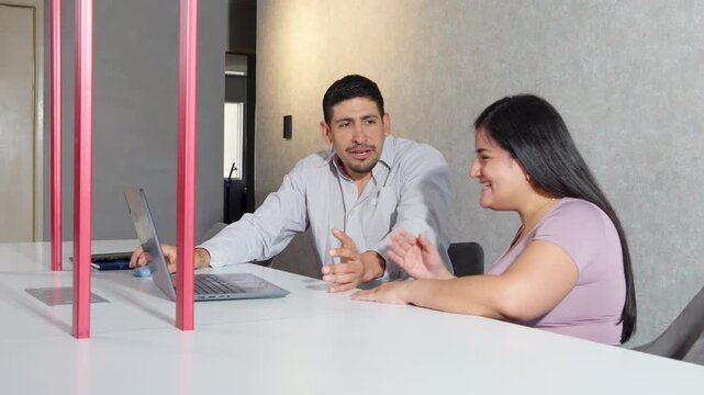 Travel agent showing exciting vacation deals to happy customer
