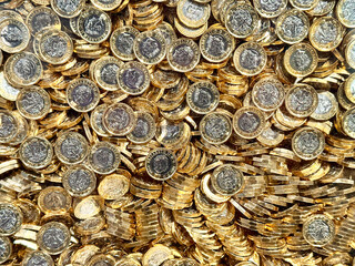 Large number of British one pound coins, Backgrounds. No people.