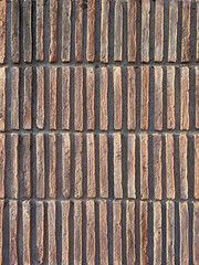 Beautiful brown-red ceramic tiles vertically oriented in the sun's rays from a close distance. Spain.