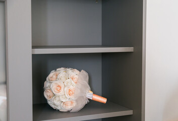 Wedding bouquet on gray shelf. Romance, elegance, and timeless beauty of decorative home styling.