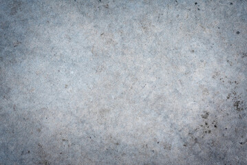 Rough, gritty gray concrete or stone texture with natural patina and dark spots. High-resolution seamless background for industrial and urban design.