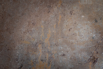Close-up of unpolished, natural stone or marble texture in gray and taupe with prominent rusty brown vertical veins. Earthy, geological background for architecture or interior design.