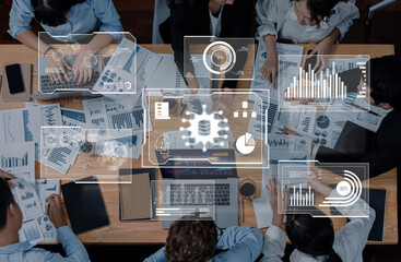 A diverse team engaging in collaborative work at a modern workspace, analyzing data trends through charts and graphs to enhance business strategies and decision-making. Trope