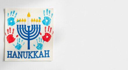 Hanukkah menorah drawing with colorful handprints on paper