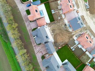 Newly completed detached family home seen at the edge of rural Essex farmland in the UK. Affordable homes can be seen on the right of this drone photo.